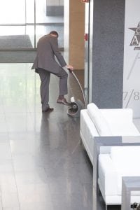 man fixing shiny shoes